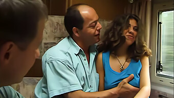 A Young Brunette Engages In A Threesome With Two Men In A Mobile Home, Performing Oral And Receiving Oral Sex.